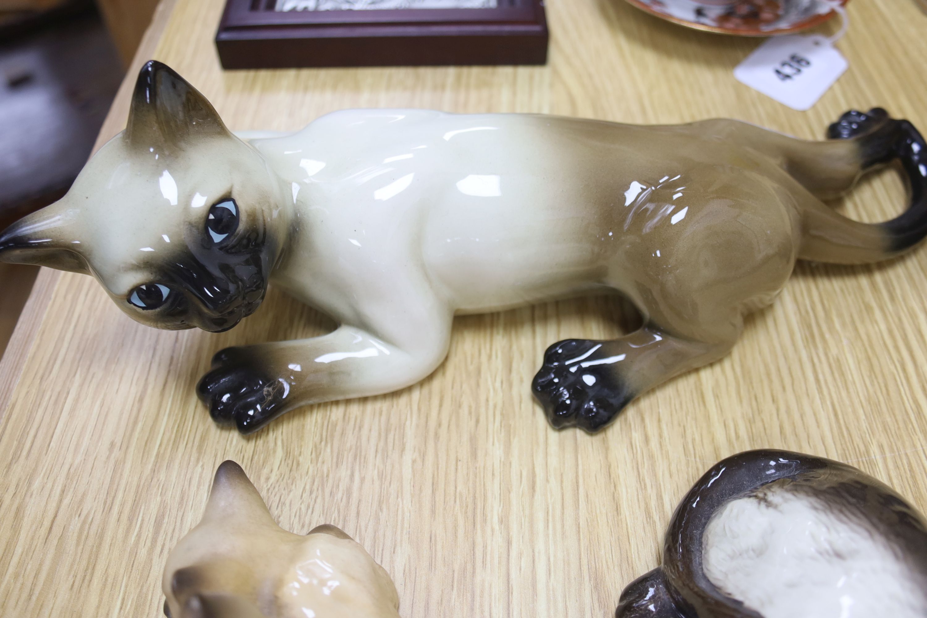 Twelve Beswick cats including Siamese